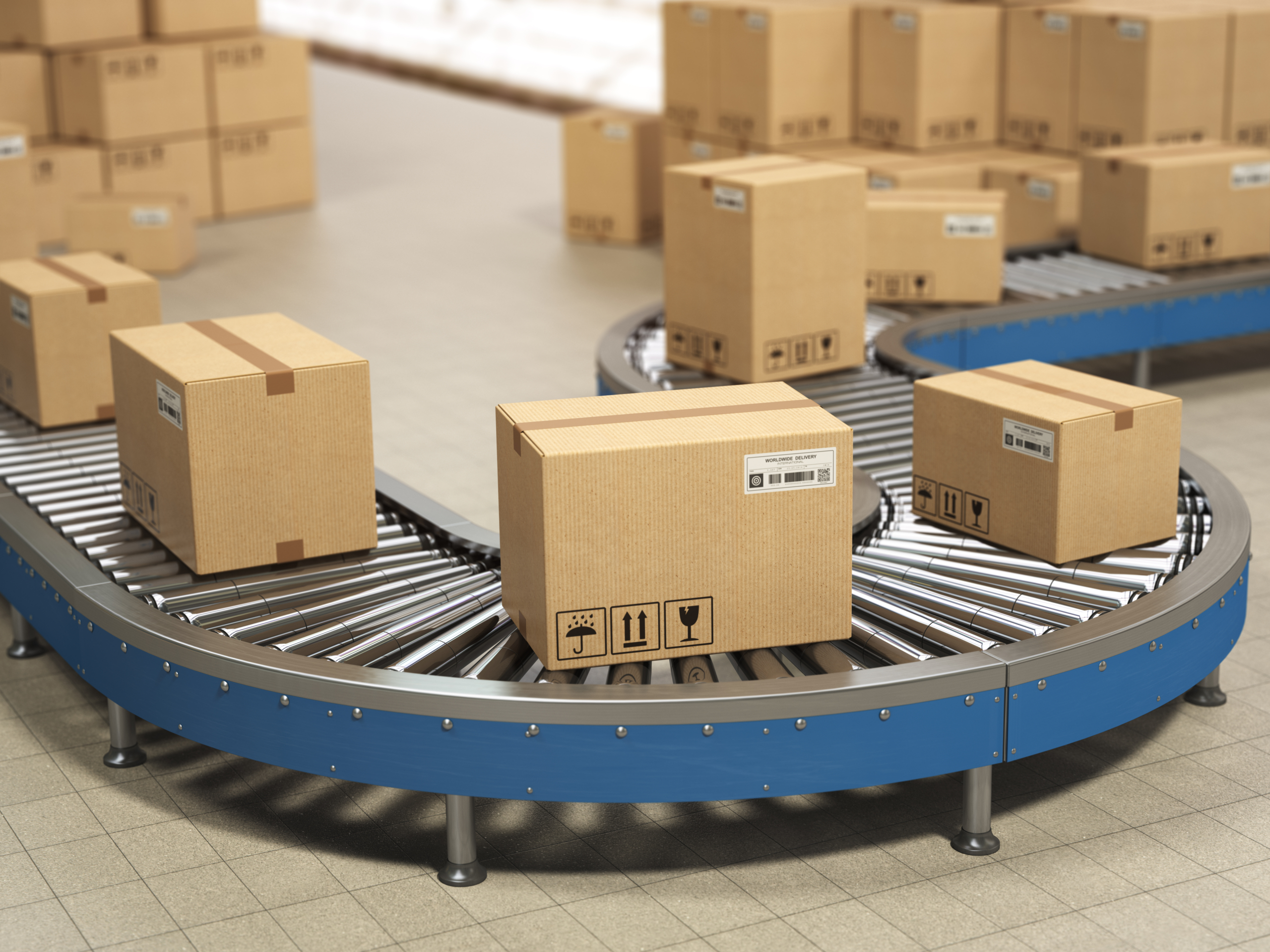 Cardboard boxes on conveyor roller in distribution warehouse, De